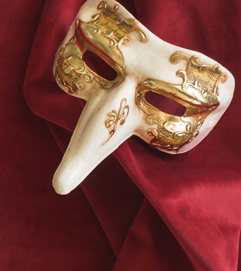 venetian-mask-with-long-se-on-red-fabric